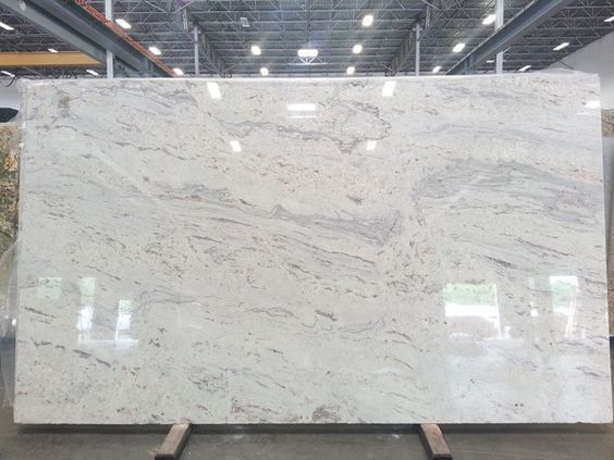 This may contain: a large white marble slab in a warehouse