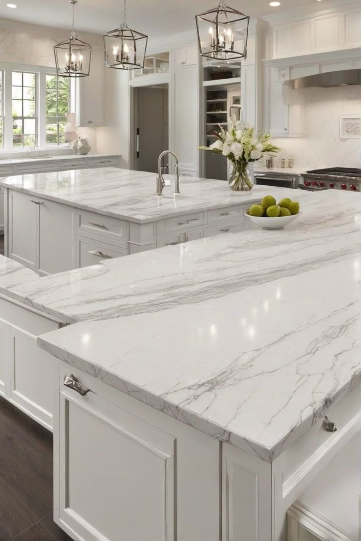This may contain: a large kitchen with marble counter tops and white cabinets, along with an island in the middle
