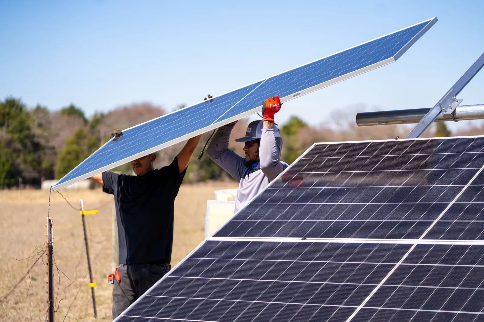 Sunaura Solar installers positioning solar panels during a residential installation