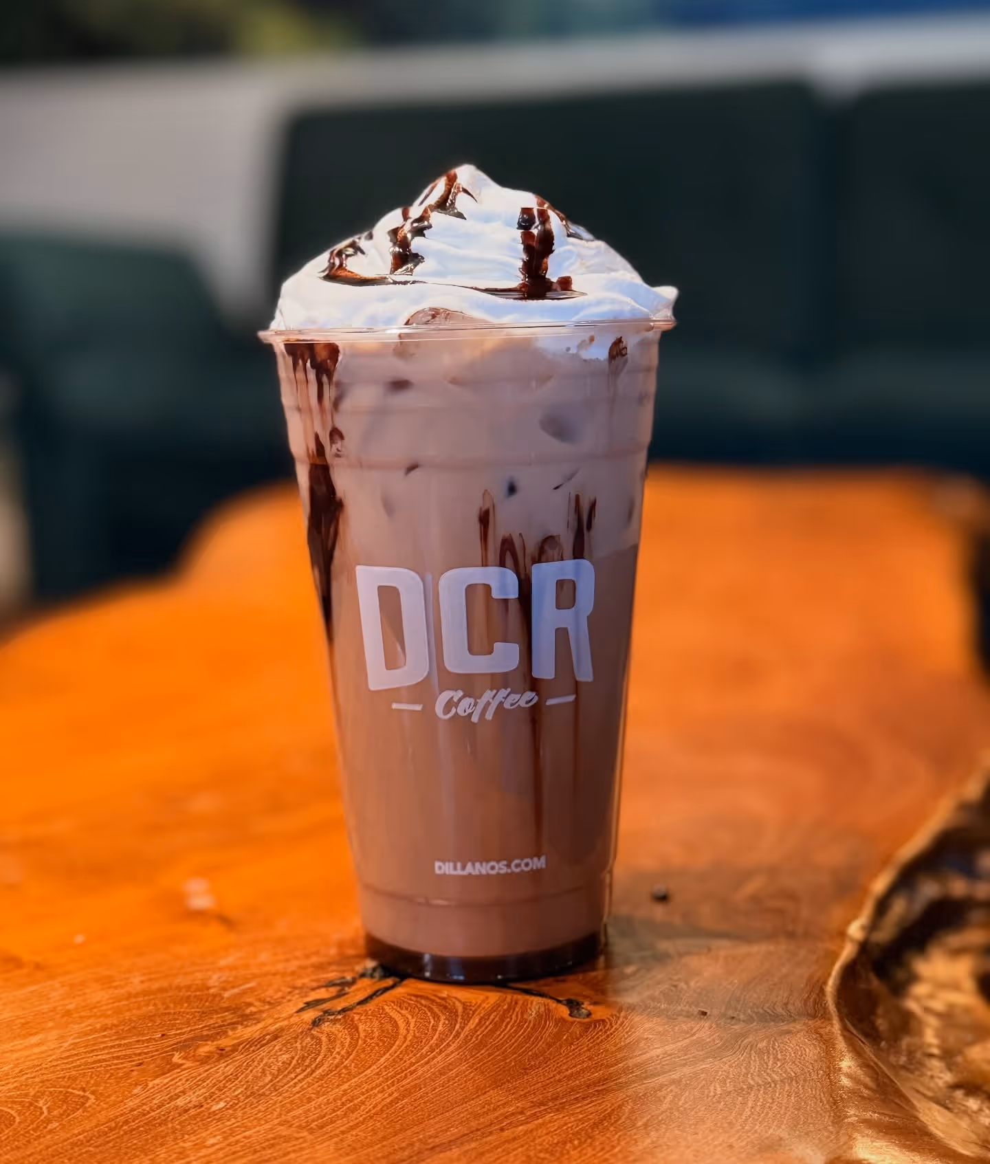 A cup of chocolate milk with whipped cream on top.