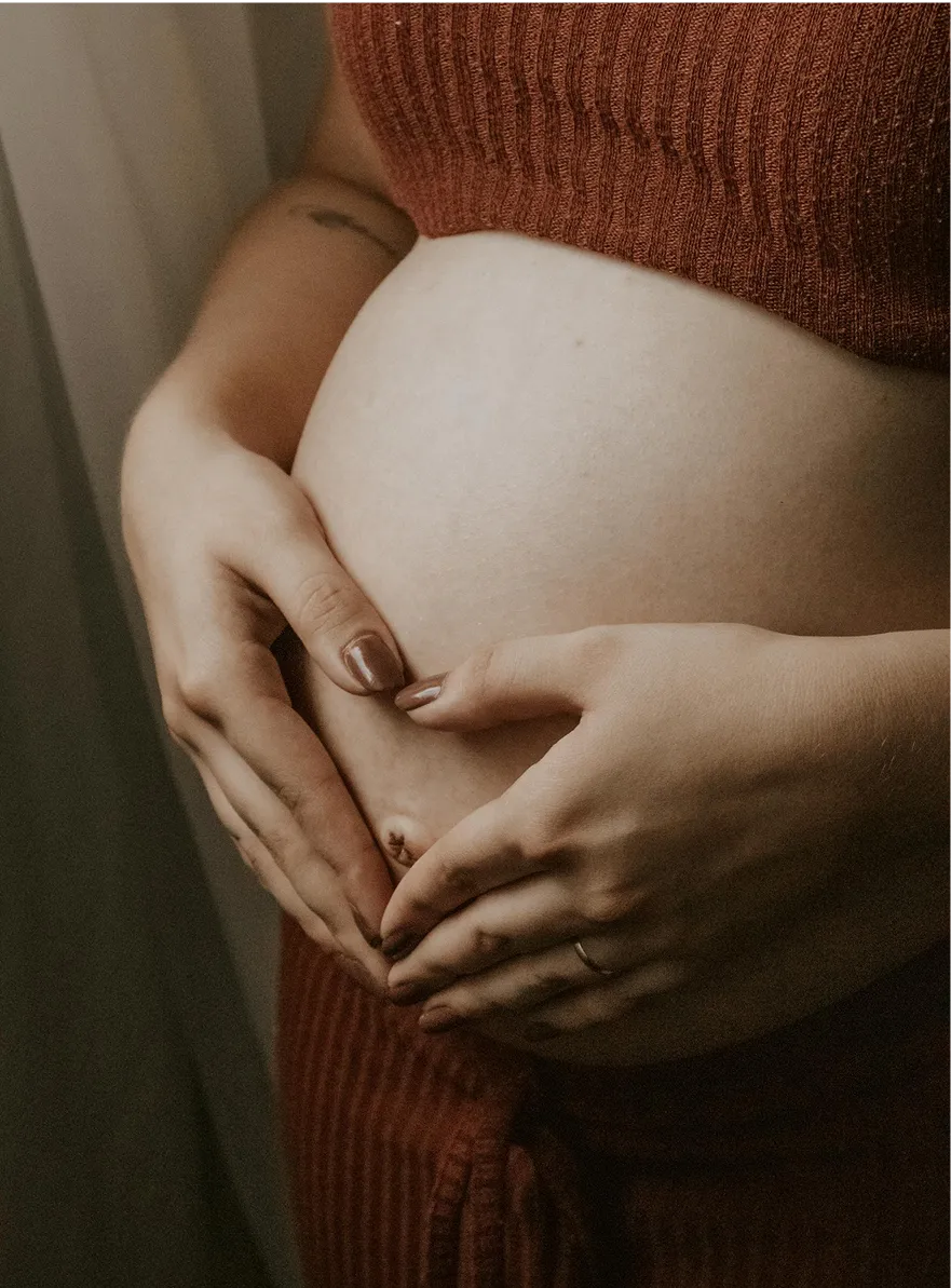 Pregnant woman holding belly