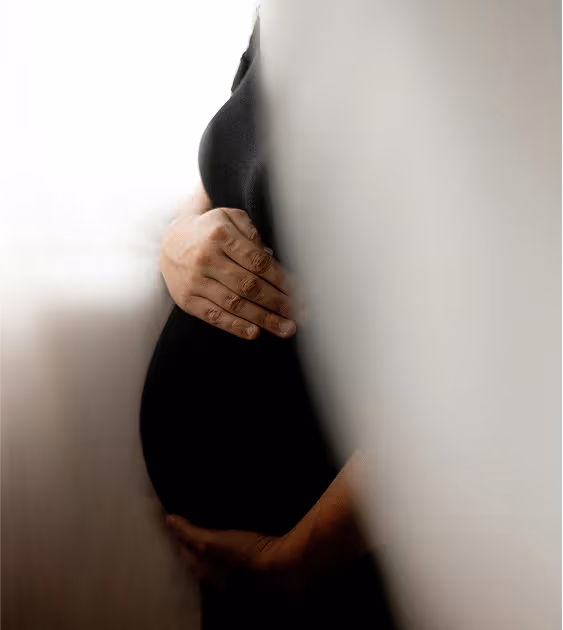 pregnant woman holding belly