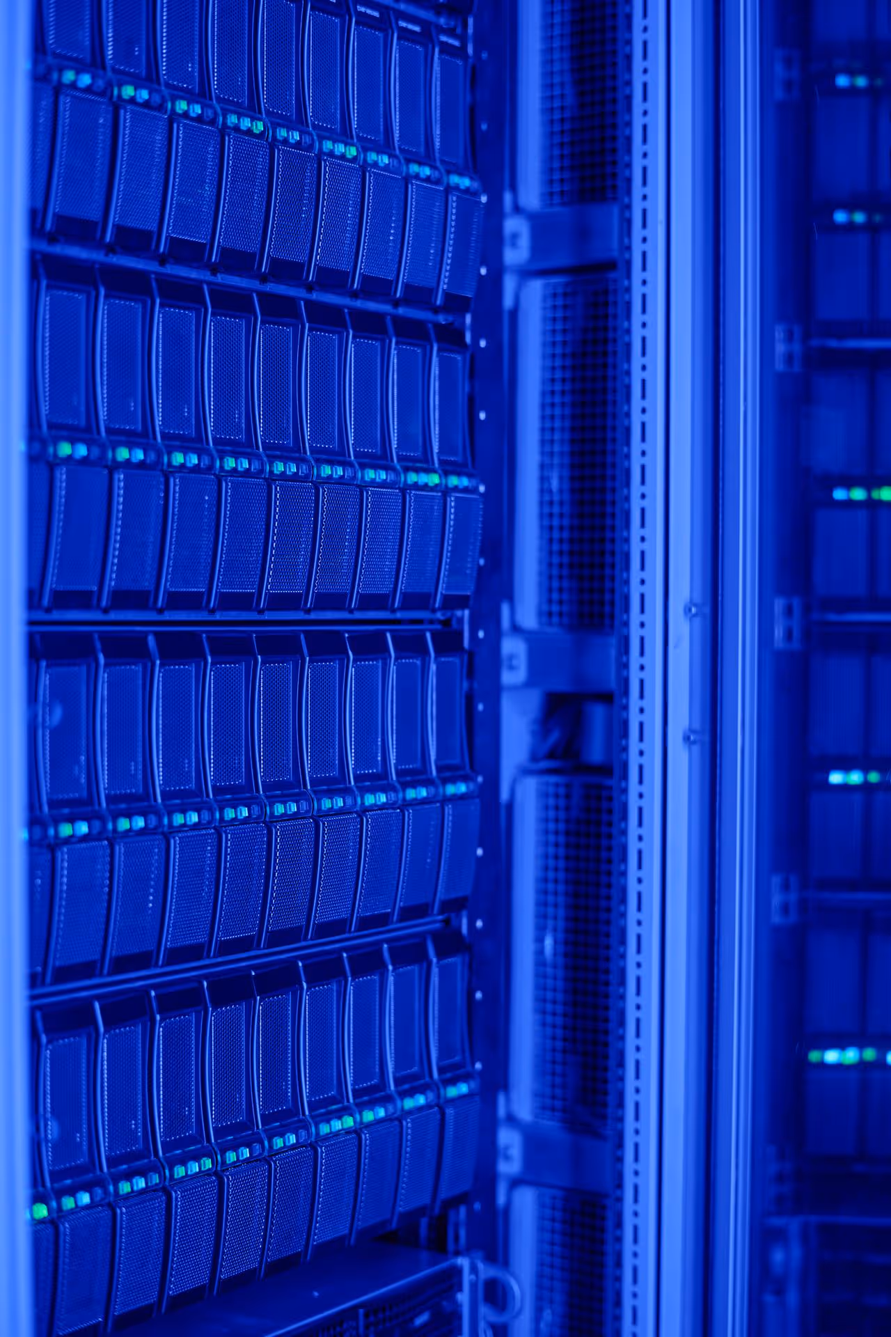 A server room with rows of data servers illuminated in blue light. The image conveys a high-tech, futuristic ambiance.