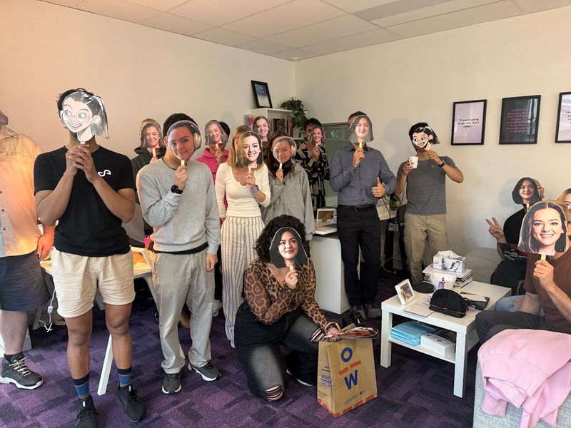 The team wearing masks they made of each other