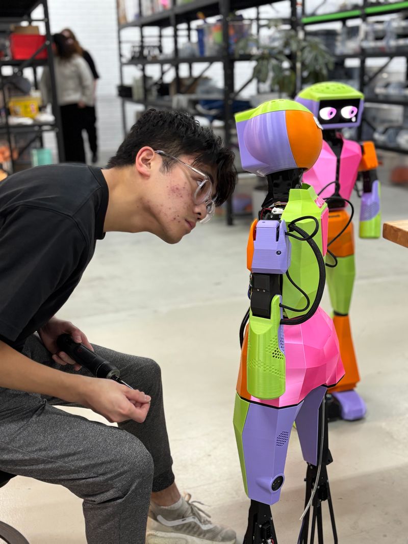 A mechanical engineer looking into Abi's face while diagnosing an issue