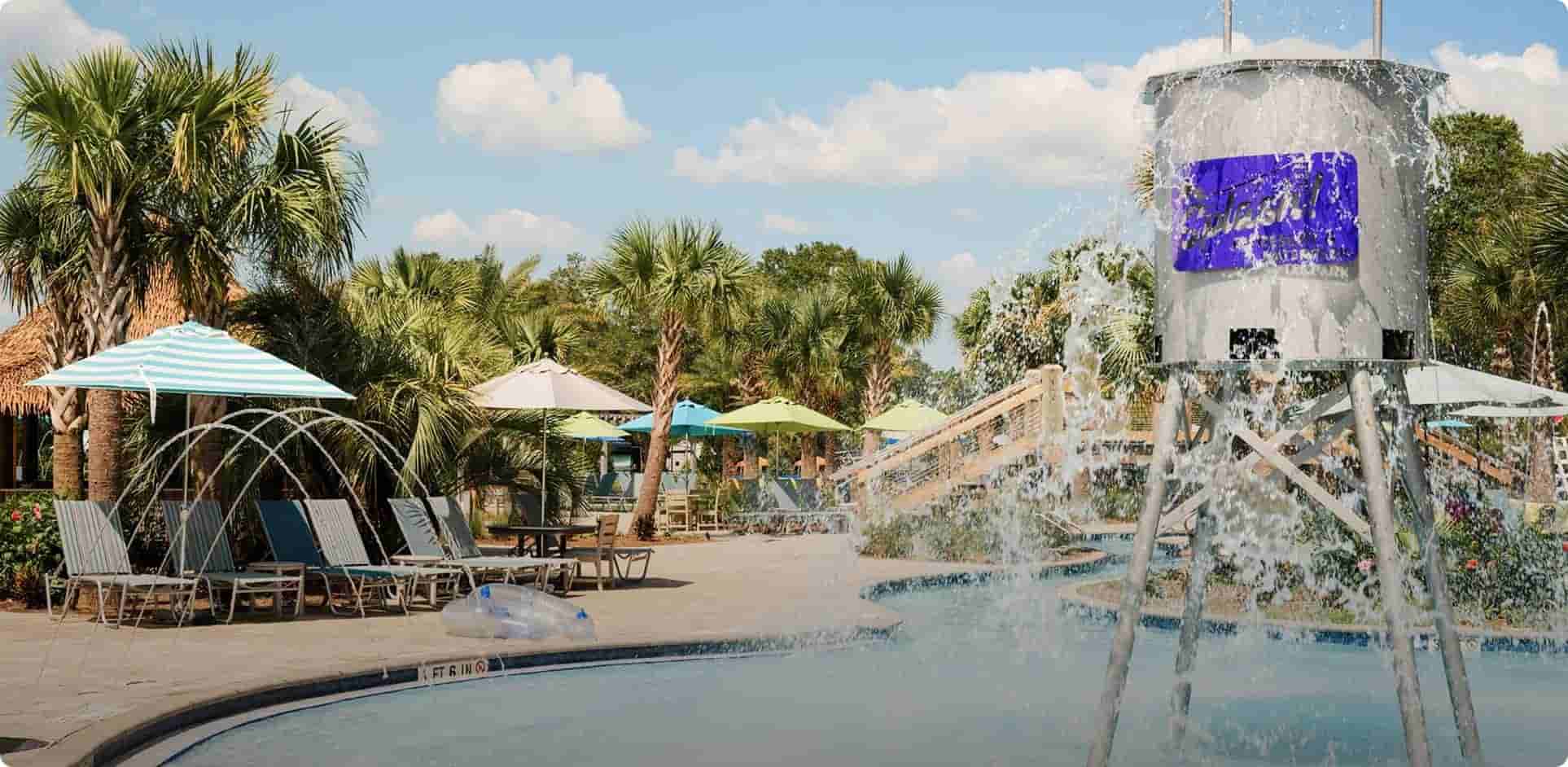 Pool with a tipping water barrel at Splash RV Resort and Waterpark in Milton, Florida