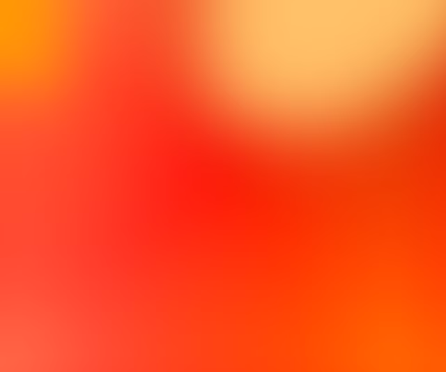 Abstract gradient background with blended warm colors including red, orange, and yellow.