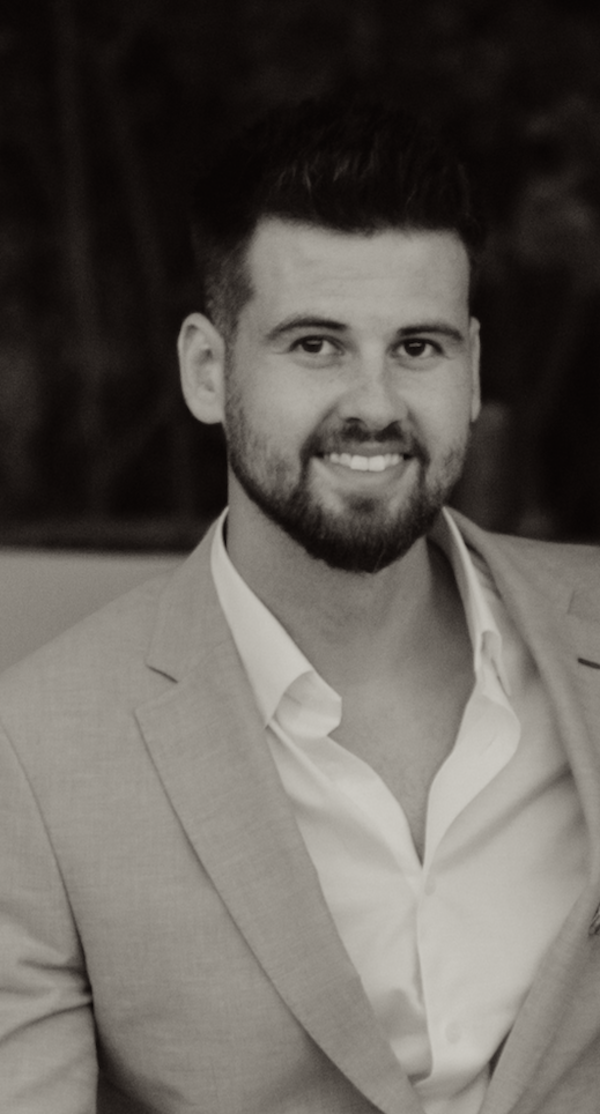 Smiling man with dark hair and beard wearing a light-colored suit jacket and white shirt. arin cubuk ceo 