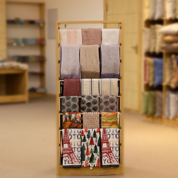 A thoughtfully arranged display of finished home textile products featuring a variety of fabrics, textures, and patterns, highlighting the design versatility and quality standards maintained by Anubav Fabrics, Karur.