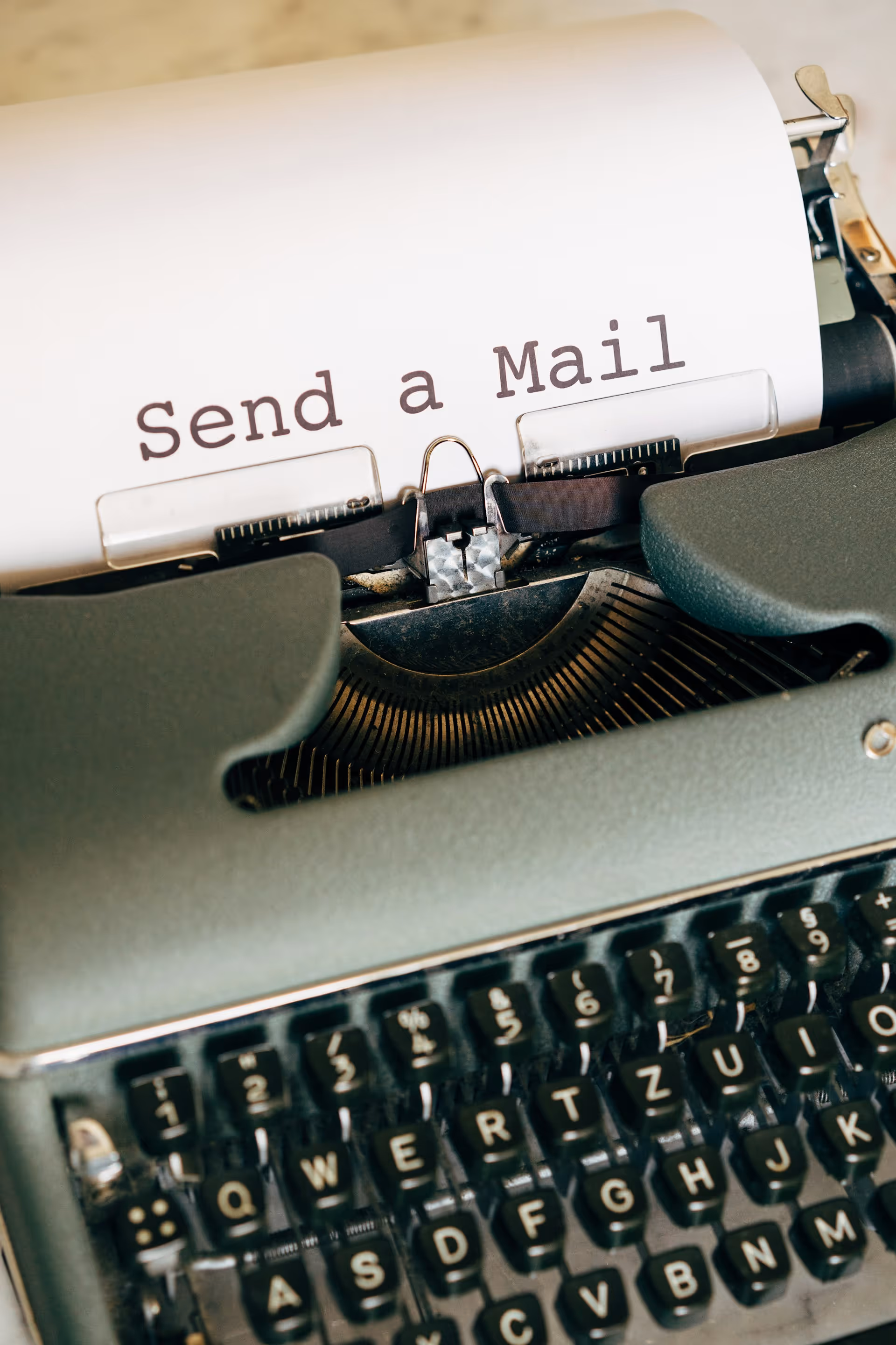 Photo of type writer with message "Send a mail", from Unsplash by Markus Winkler