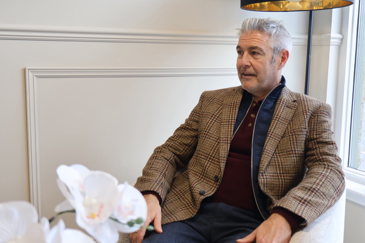 Craig Jardine speaking with client in the Sterling Wealth office