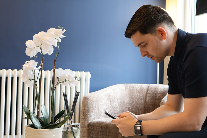 Financial adviser sitting on phone speaking to clients.