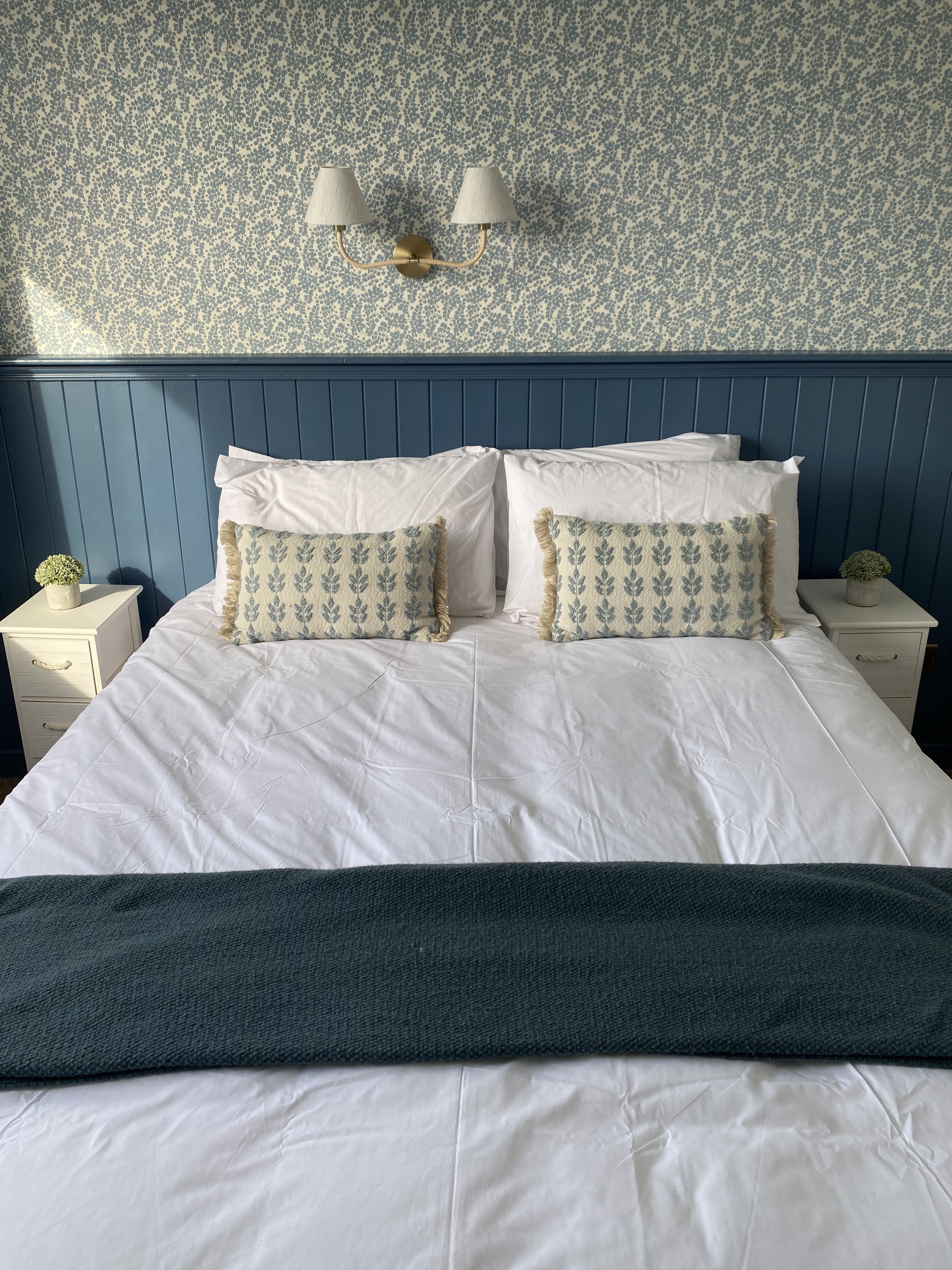 A modern double room with king bed and private ensuite