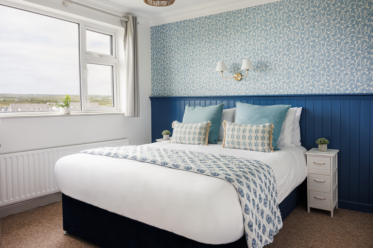 A modern double room with king bed and private ensuite