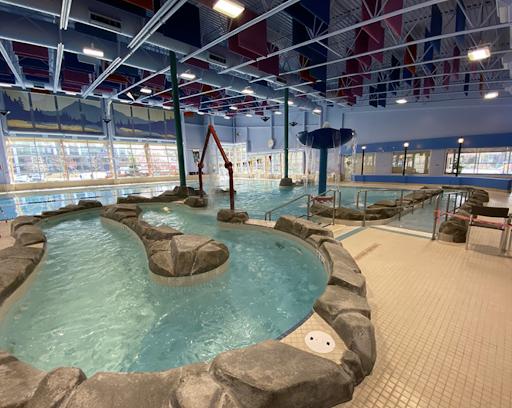 Indoor pool at Chilliwack Landing Leisure Centre, featuring slides and water activities.