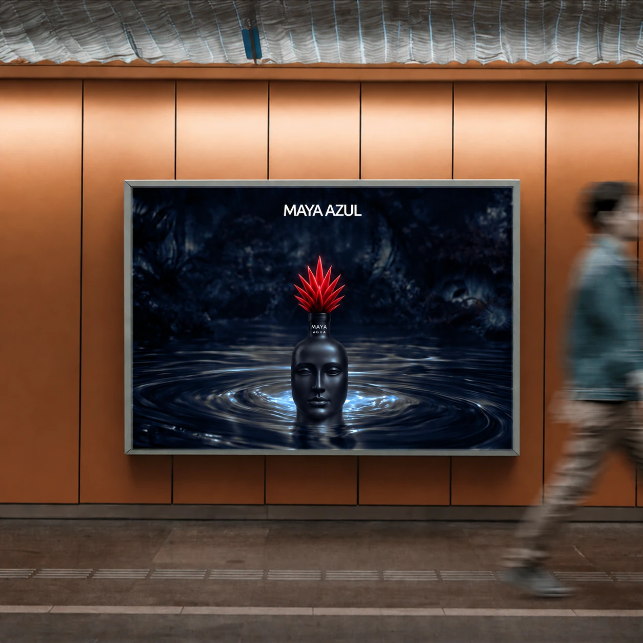 Maya Azul poster in an orange-walled passage, showing a face-shaped bottle and red cap surrounded by water.