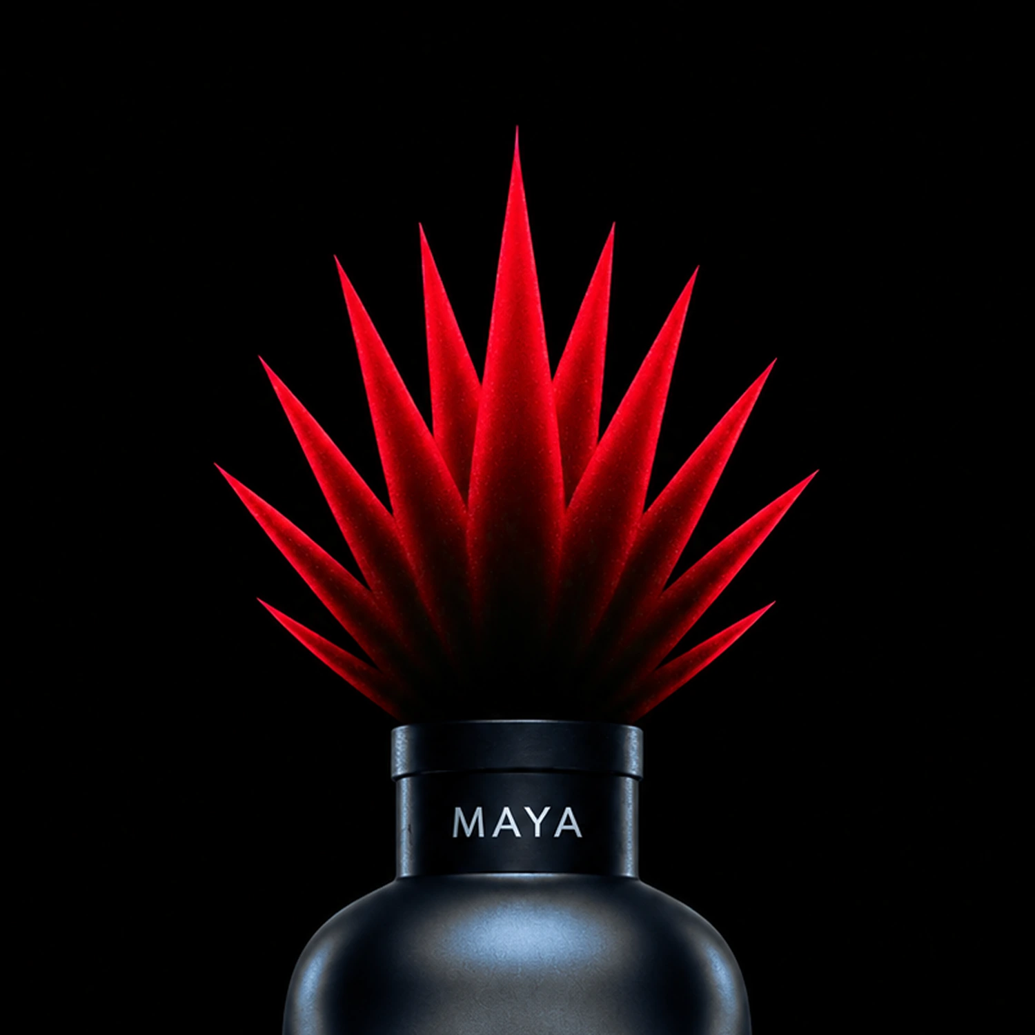 Close-up of the red pointed-leaf cap on the black Maya bottle against a black background.