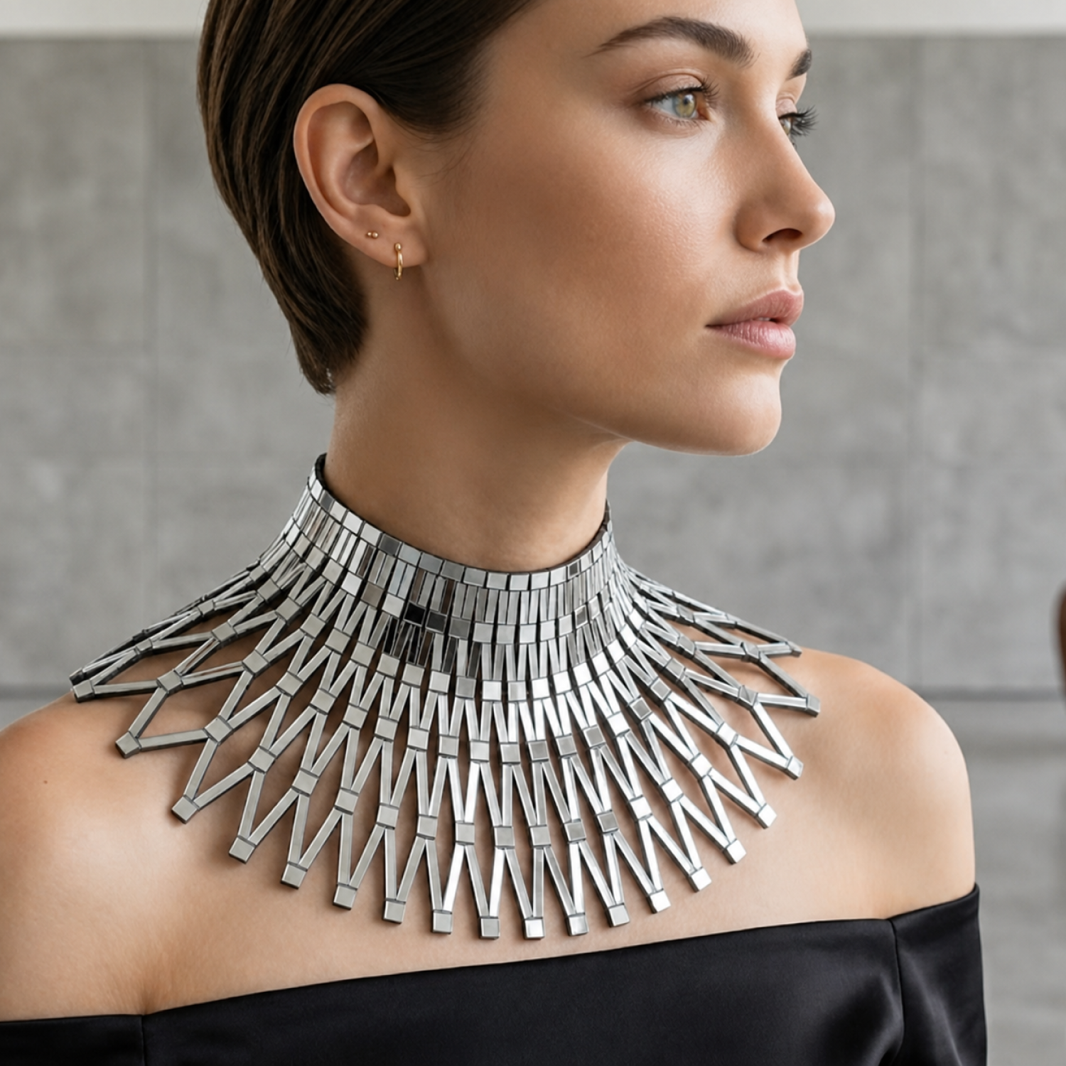 Cleo: black-and-white detail of the leather and mirrored acrylic necklace, with the Vogue Arabia logo.