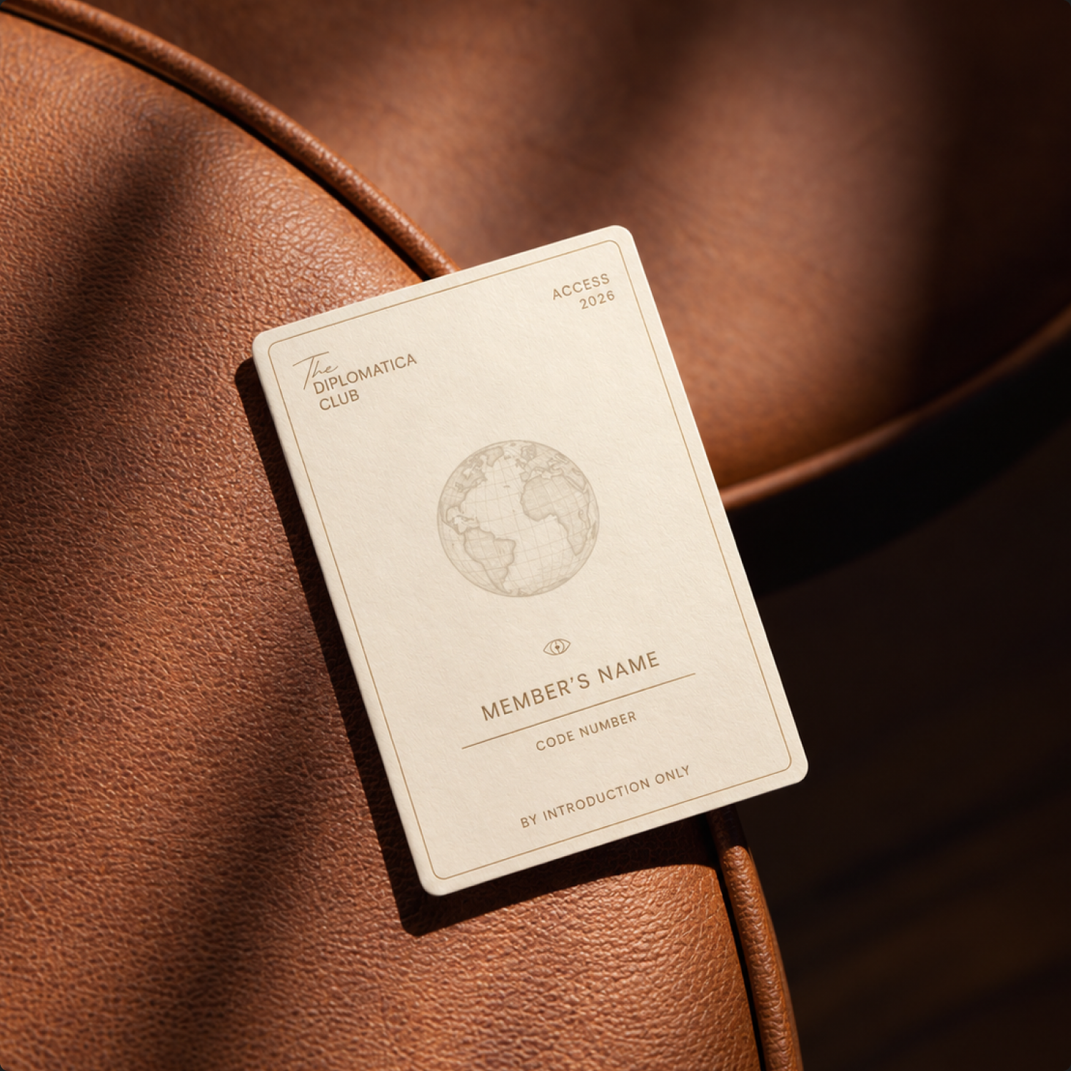 Diplomatica invitation card with cream and brown typography.