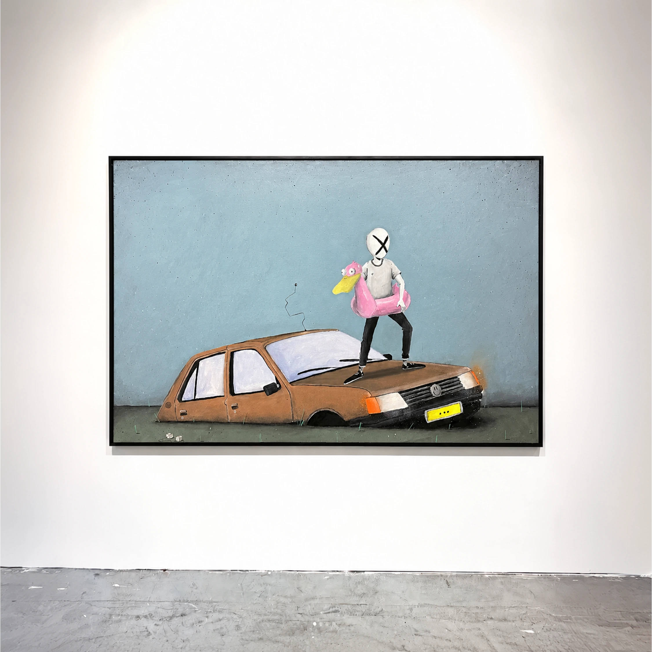A framed painting of a masked figure standing on a brown car against a blue-grey background.