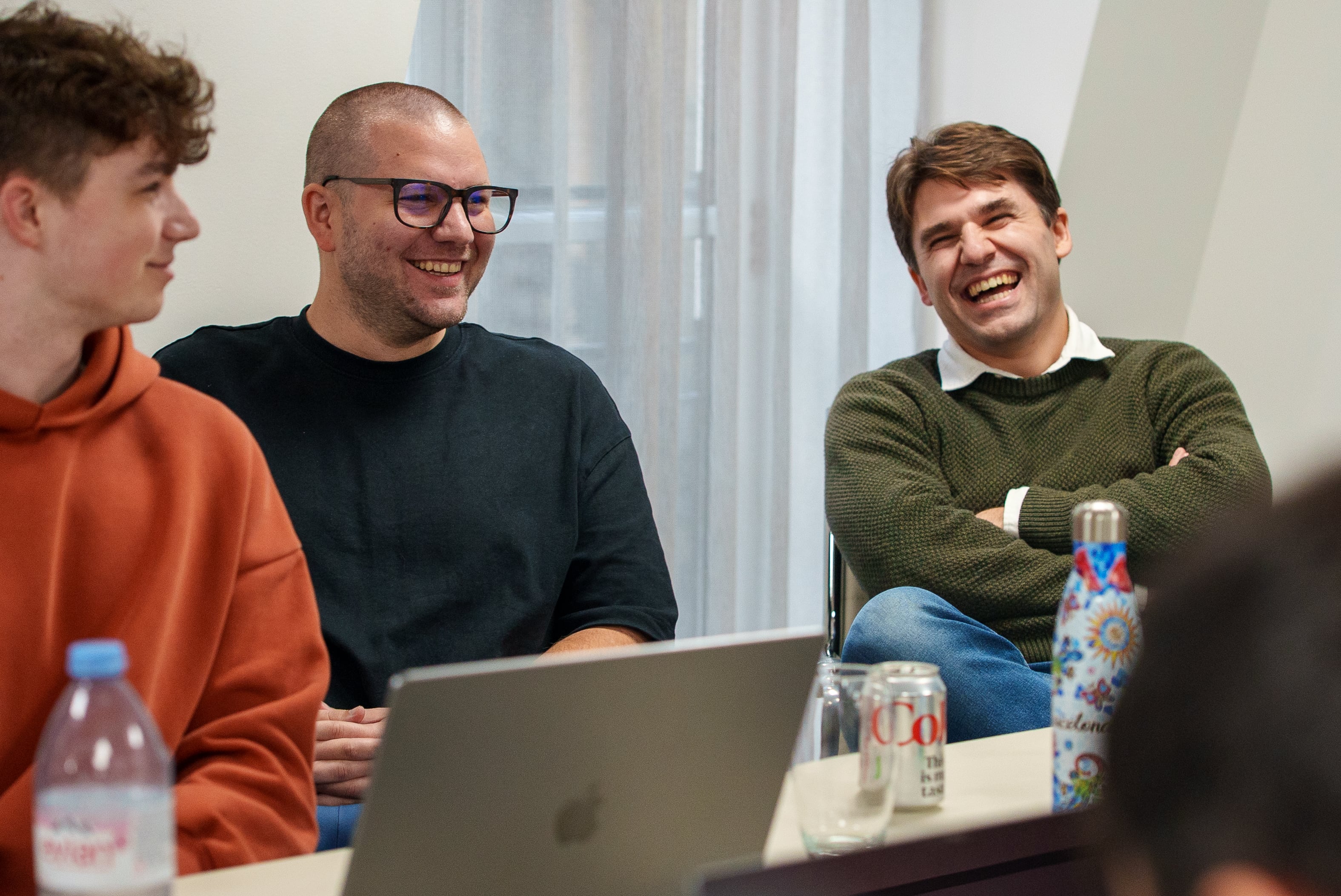 Khan Baykaner and other team members collaborating in a business meeting.