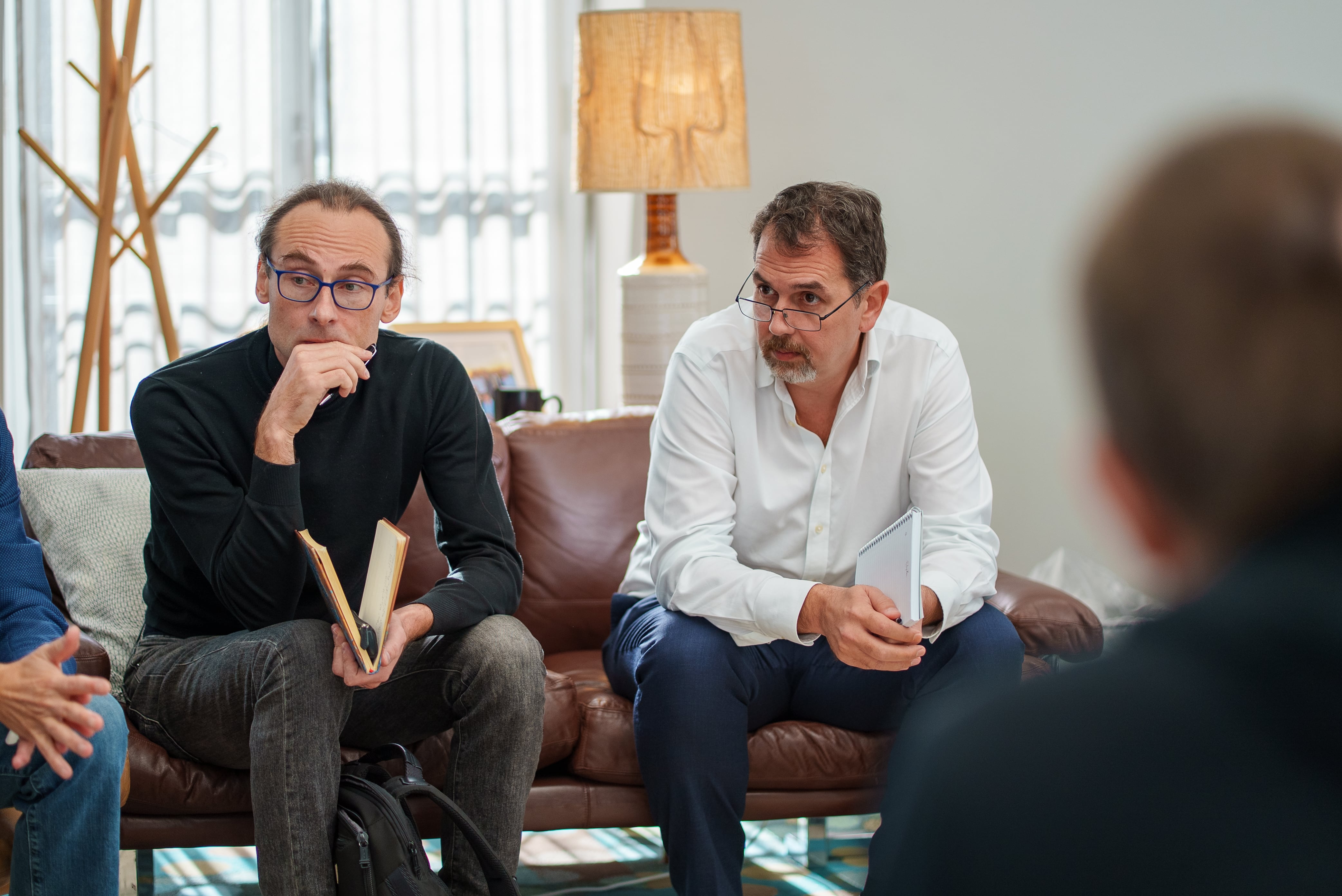 Alex Bronstein, Apostolos Katsaris and other team members collaborating in a business meeting.