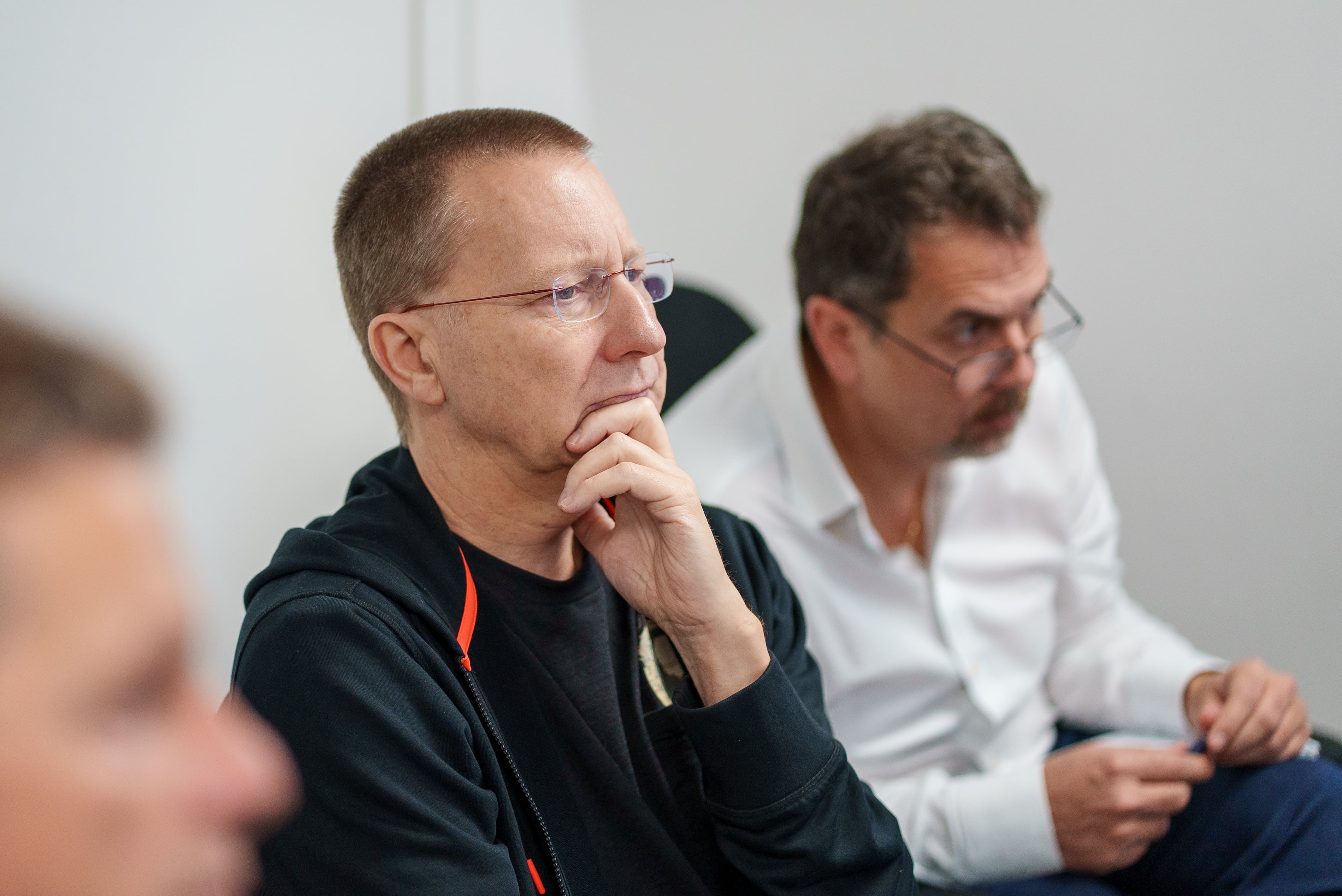 Damon Mannion, Apostolos Katsaris and other team members collaborating in a business meeting.