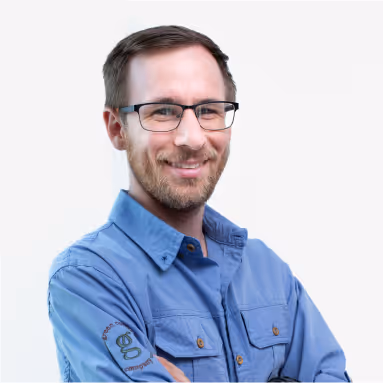 Headshot of Robbie Pritts, a man with short hair, smiling in a business casual shirt.