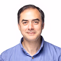 Professional headshot of Juan Miguel Jaramillo, a man with dark hair, smiling in a suit.