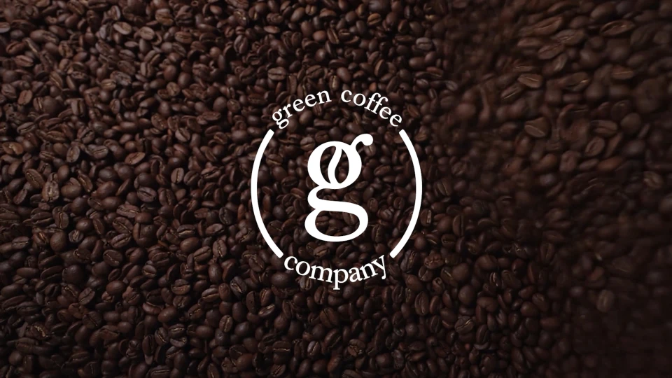 Green Coffee Company logo over a bed of roasted coffee beans.