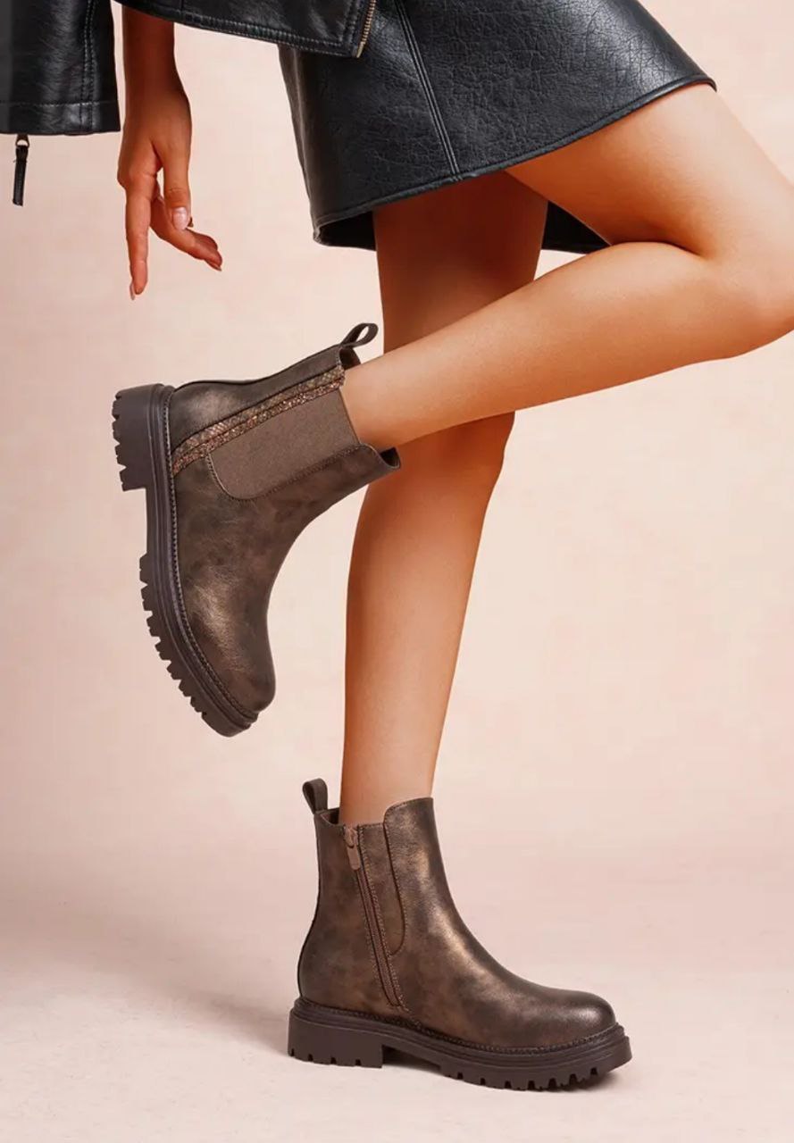 Craquez pour ces bottines à élastiques pour femme au look minimaliste et ultra tendance. Facile à enfiler grâce à leurs larges bandes élastiques latérales elles assurent un maintien confortable et une silhouette épurée. Leur semelle épaisse crantée ajoute une touche urbaine tout en offrant une bonne stabilité.
Semelle extérieure antidérapante avec plateforme robuste.
Couleur Bronze