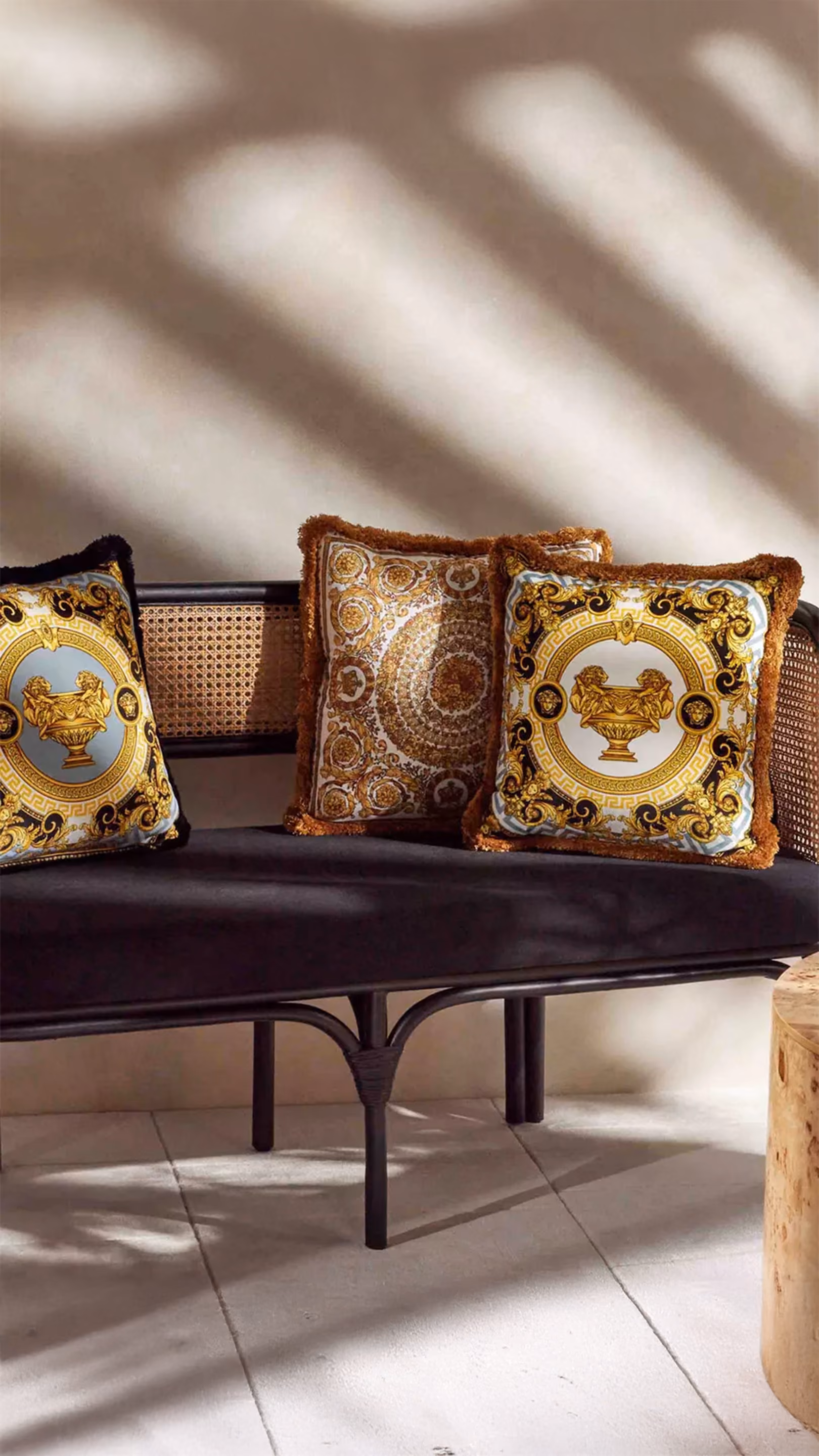 Modern living room with beige sofa, dark blue armchair, marble coffee table, and vertical gold-toned wall panels.