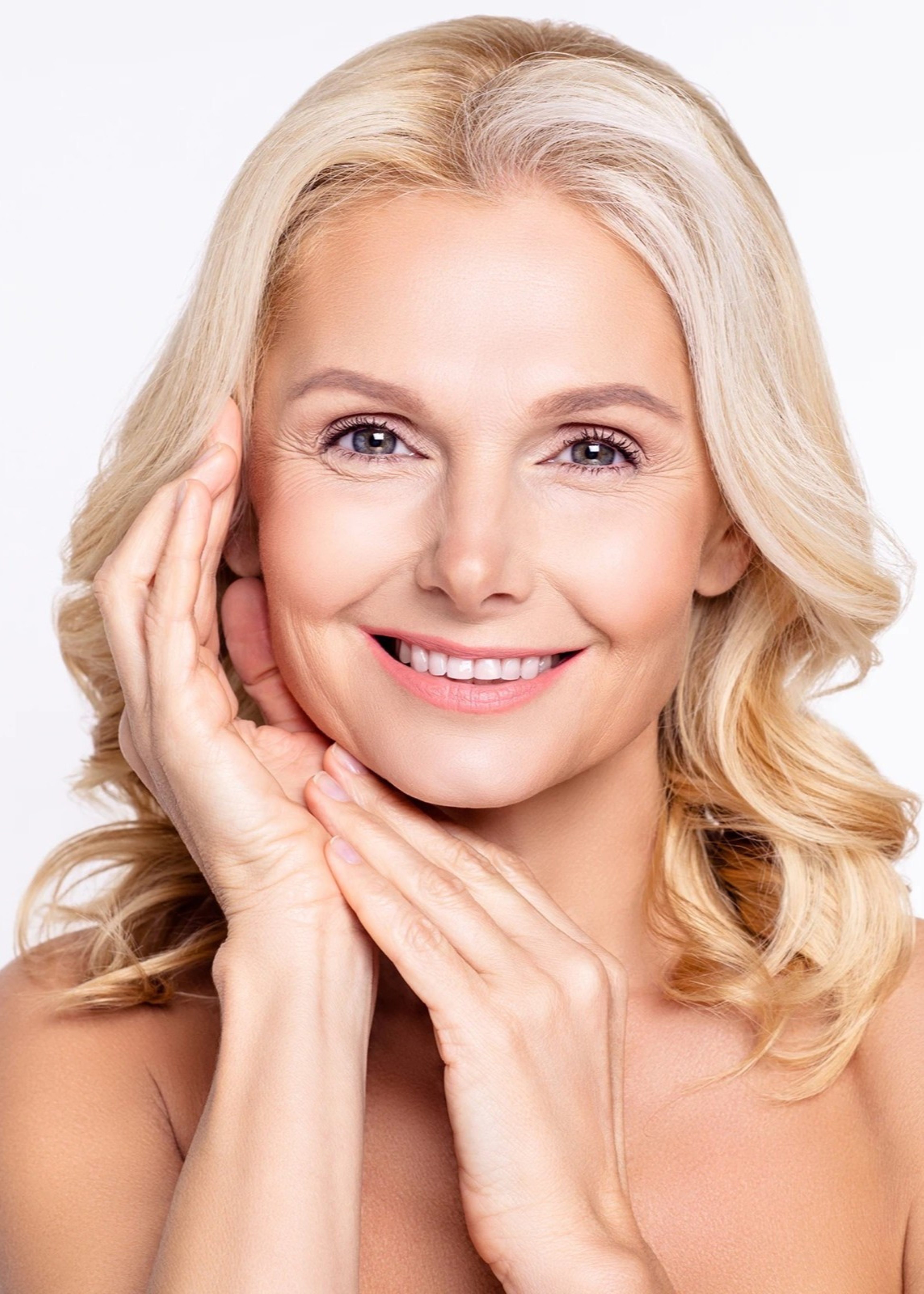 Woman smiling with her hands on her face