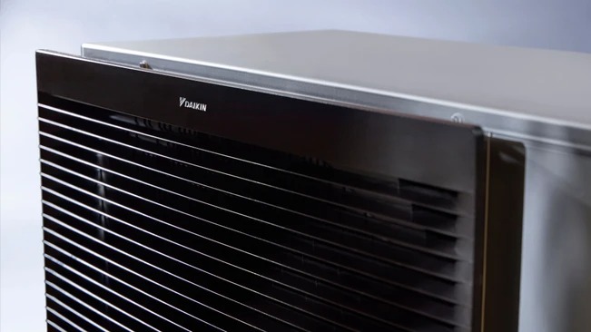 Close-up of a black Daikin air conditioning unit with horizontal vents.