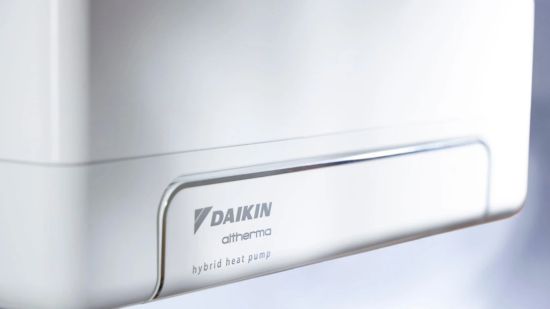 Close-up of a white Daikin Altherma hybrid heat pump unit with logo and model name visible.