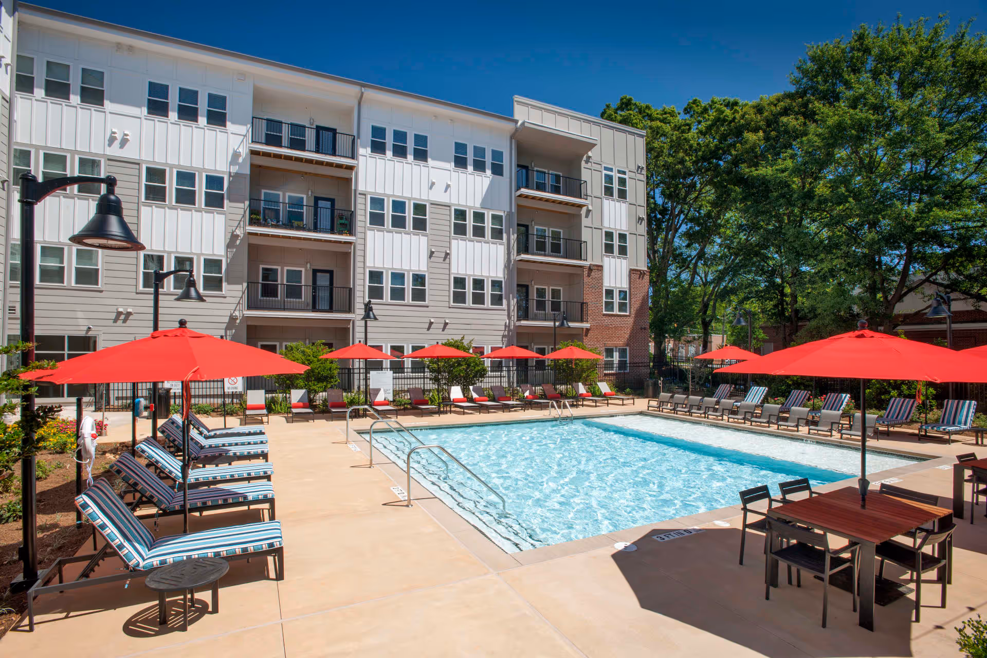 swimming pool with lounge chairs and umbrellas