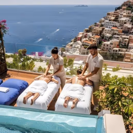 Two guests receiving outdoor spa massages overlooking the Positano coastline