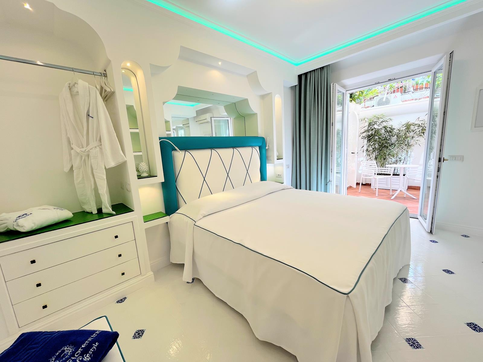 Elegant suite bedroom with sea-view terrace at Villa Fiorentino