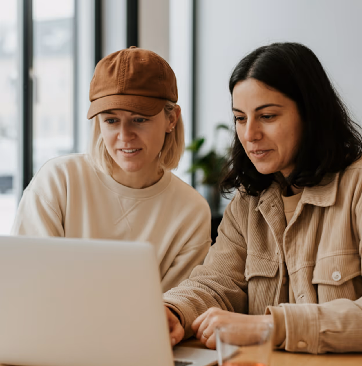 Deux femmes entrepreneures collaborant sur un projet sur ordinateur.