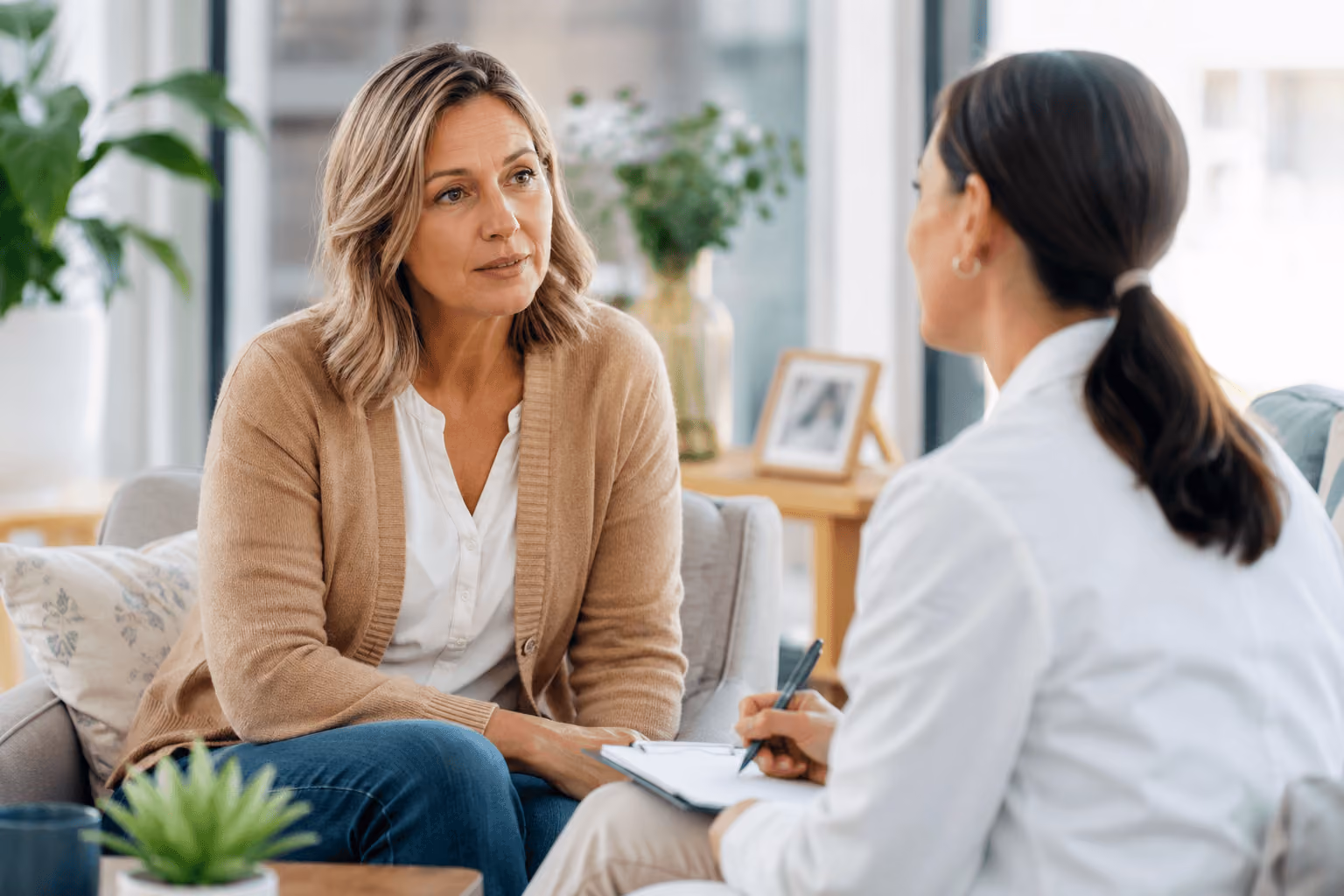  Woman in Cary, North Carolina discussing hormone replacement therapy and menopause symptoms with a wellness provider
