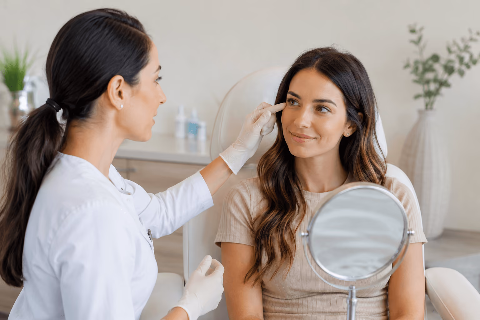 Young woman consulting with a medical aesthetic provider about preventative Botox treatment in Cary, North Carolina before early wrinkles develop.