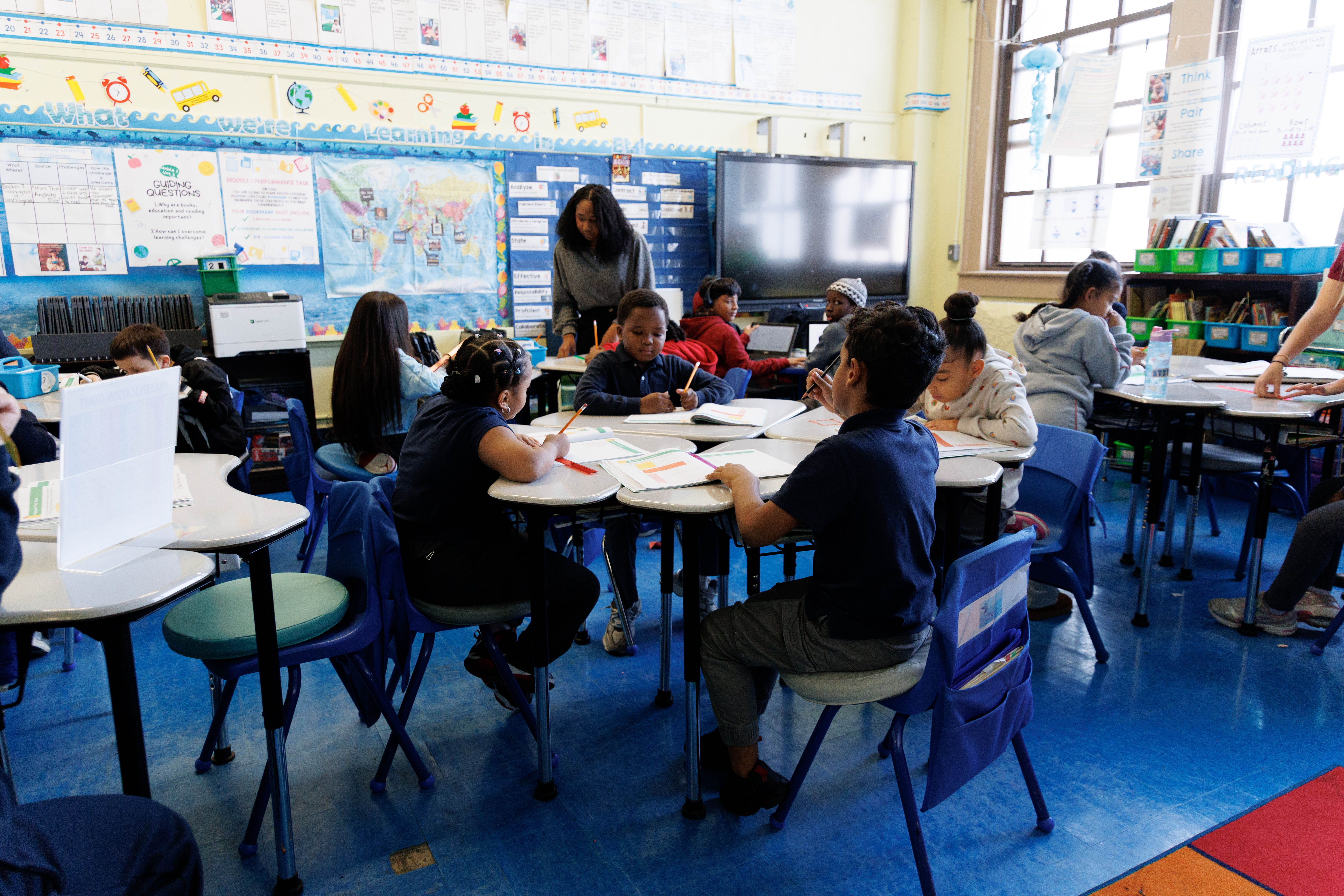 Students working in small groups during a classroom lesson