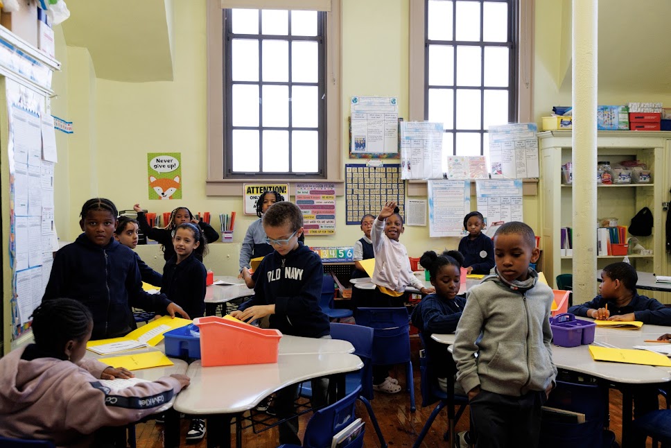 Elementary students working at desks in a decorated classroom