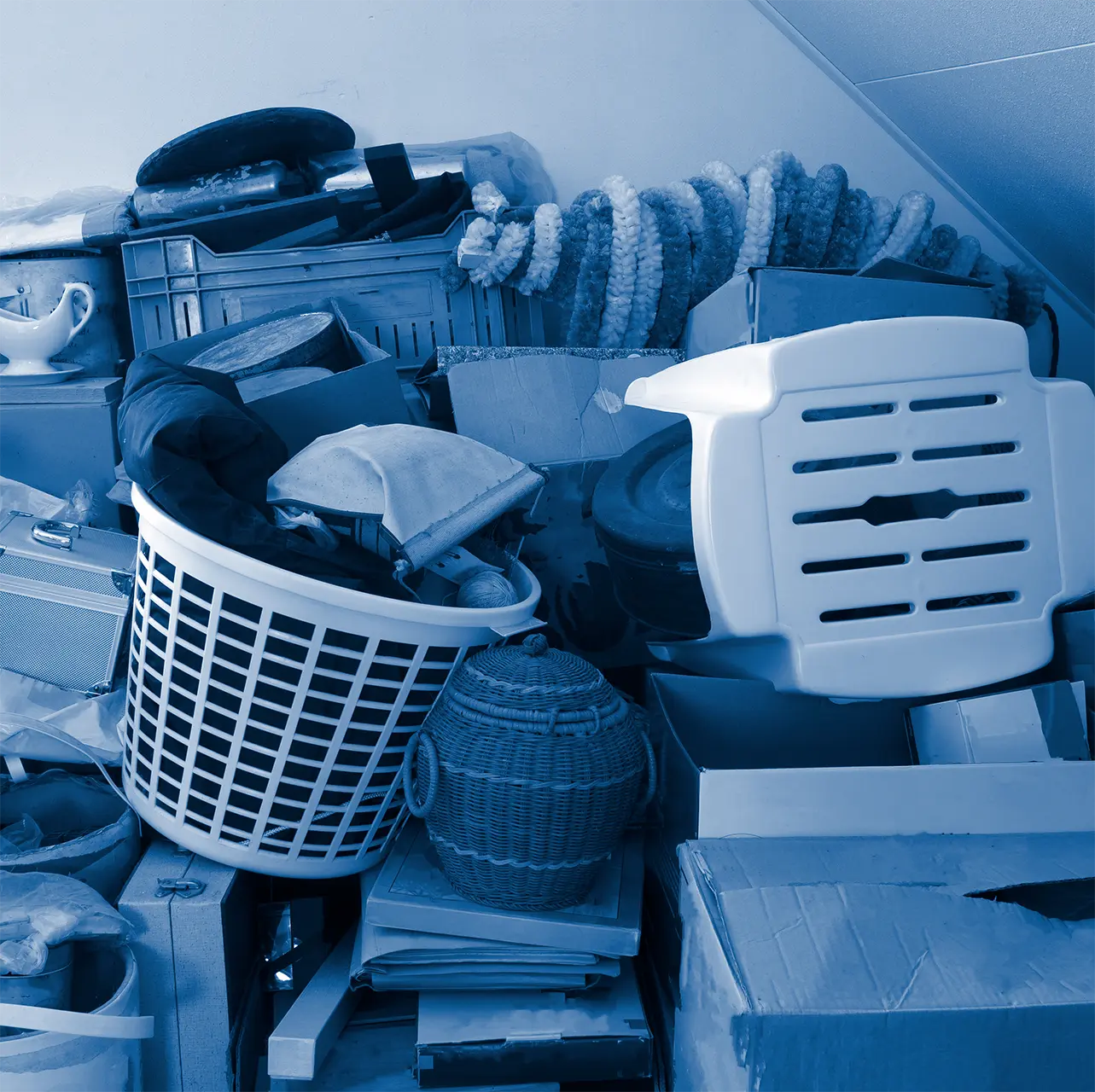 Household boxes, crates, and furniture piled up to the ceiling