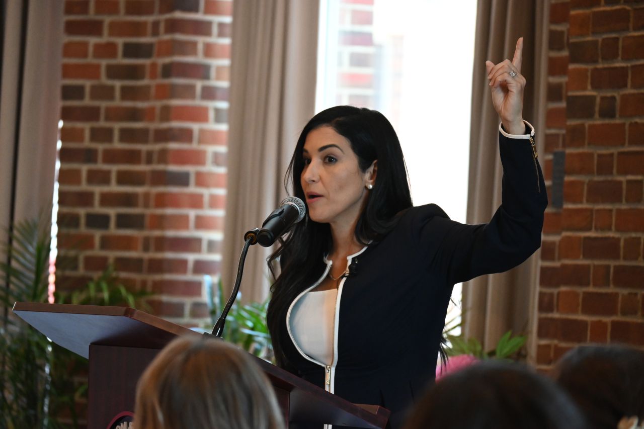 Nayli Russo Long speaking at the All for Her Luncheon