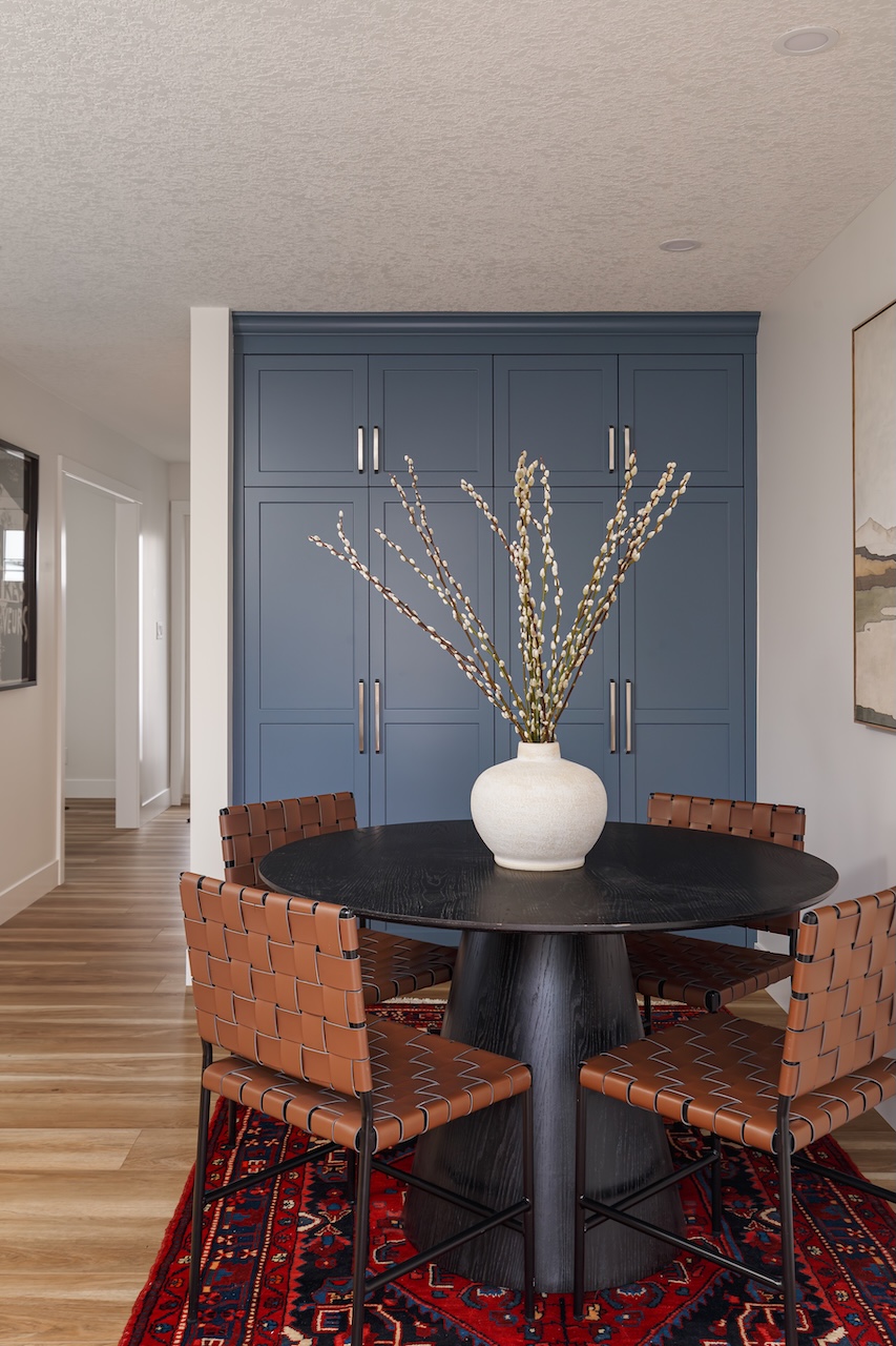 Bright modern bathroom with wooden cabinets, double sink vanity, large mirror, and a bathtub by a window showing an outdoor view by Marvel Cabinetry.
