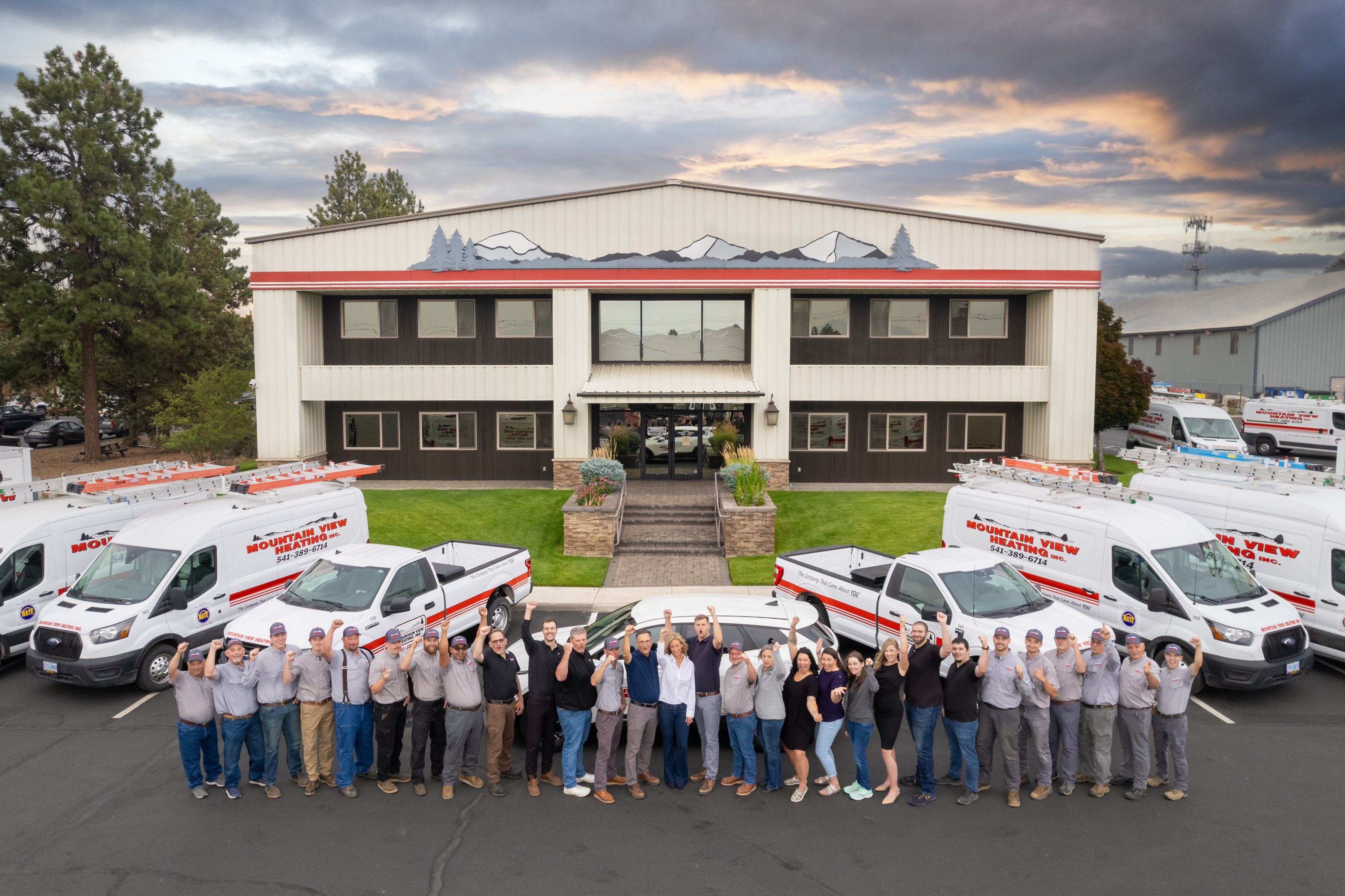 Mountain View HVAC company team and fleet posing in front of their corporate building