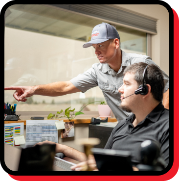 Technician assisting a customer service representative at Mountain View Heating, emphasizing teamwork in emergency repair services.