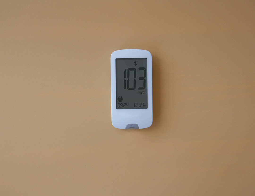 homeowner looking at thermostat - heat pump repair bend or