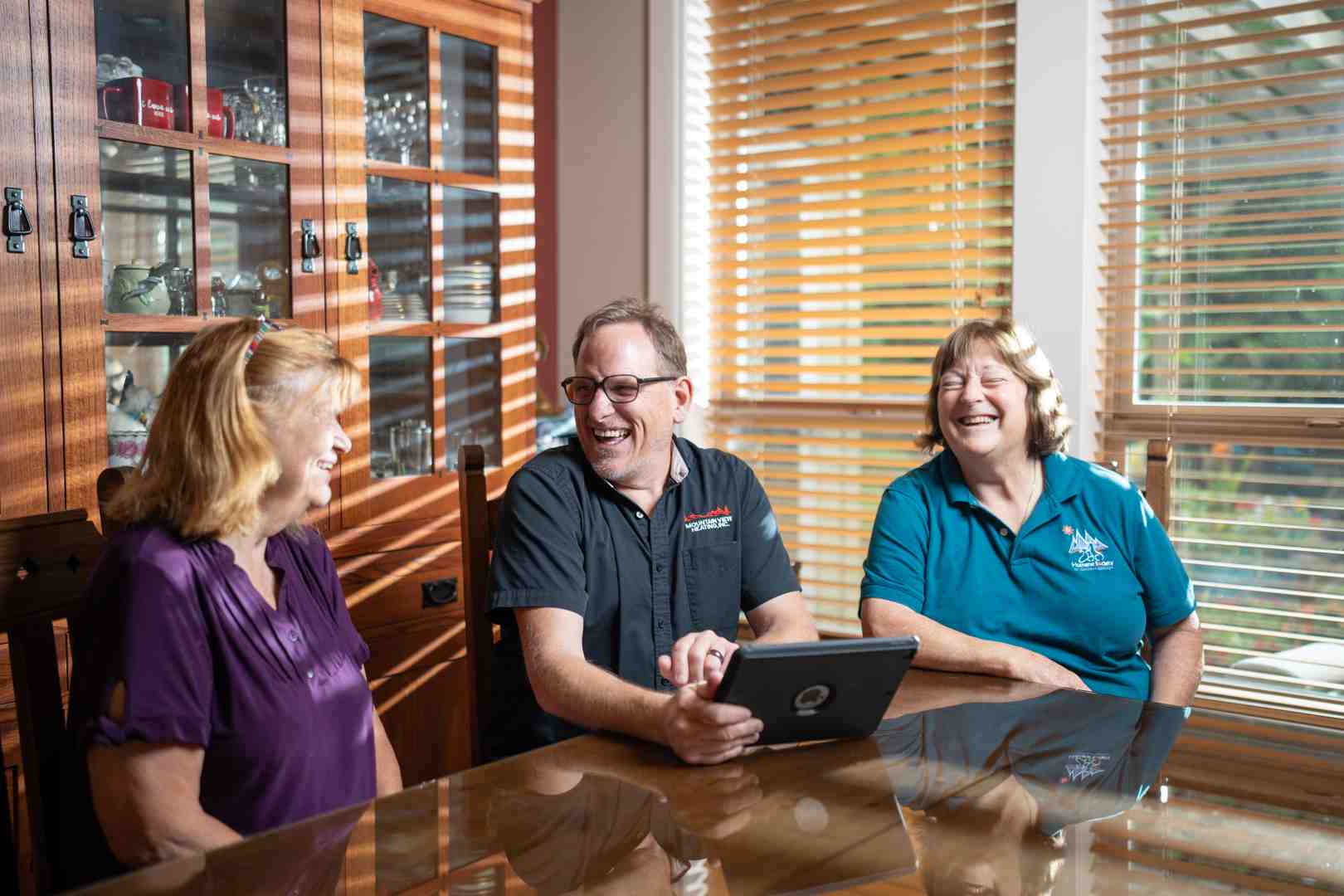 Happy family relaxing in a comfortable living room with perfect indoor temperature - benefits of choosing a nate certified